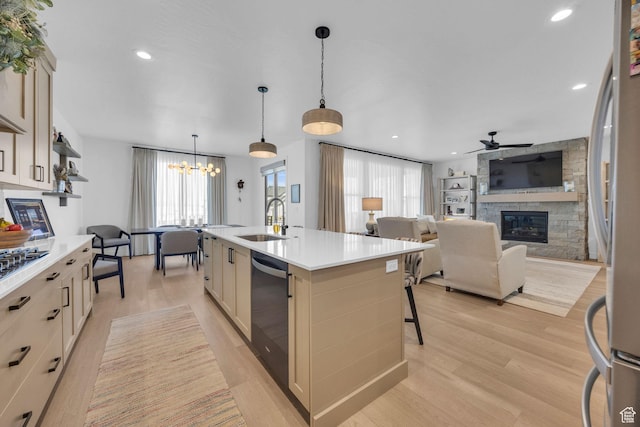 2119 N 520 W, Centerville, UT 84014 - kitchen with light countertops, a sink, a fireplace, and stainless steel appliances