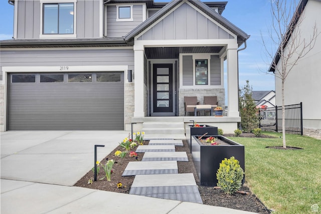 2119 N 520 W, Centerville, UT 84014 - view of front of house featuring a garage, board and batten siding, concrete driveway, and stone siding