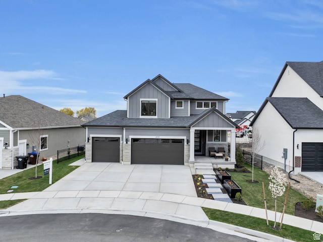 2119 N 520 W, Centerville, UT 84014 - view of front of home with board and batten siding, a porch, fence, a front lawn, and concrete driveway