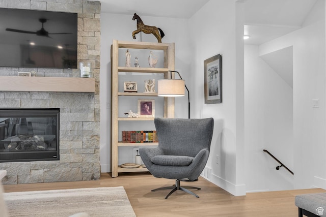 2119 N 520 W, Centerville, UT 84014 - sitting room featuring baseboards, ceiling fan, a stone fireplace, and wood finished floors