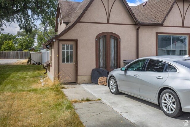 67 N 200 E, Tremonton, UT 84337 - view of front of house with stucco siding, a shingled roof, and a front yard