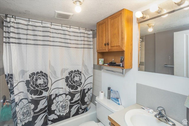 67 N 200 E, Tremonton, UT 84337 - bathroom featuring a textured ceiling, visible vents, toilet, vanity, and shower / bath combination with curtain
