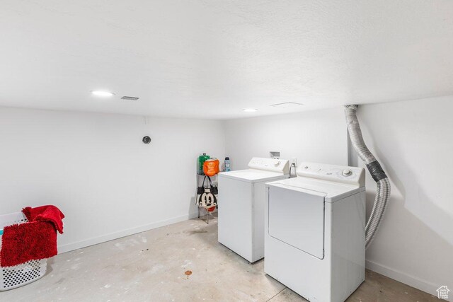 67 N 200 E, Tremonton, UT 84337 - laundry room with baseboards, a textured ceiling, and separate washer and dryer