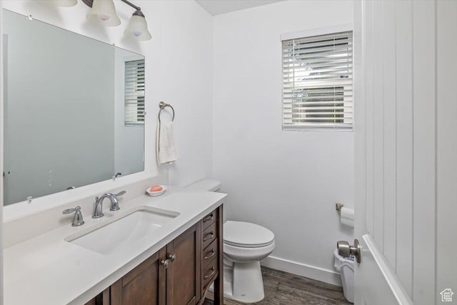 67 N 200 E, Tremonton, UT 84337 - half bath featuring baseboards, wood finished floors, toilet, and vanity