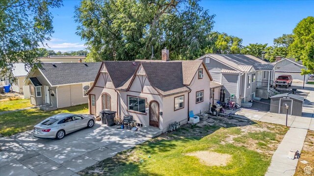 67 N 200 E, Tremonton, UT 84337 - view of front of home with stucco siding, a shingled roof, a chimney, and a front lawn