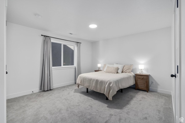 carpeted bedroom with baseboards and visible vents