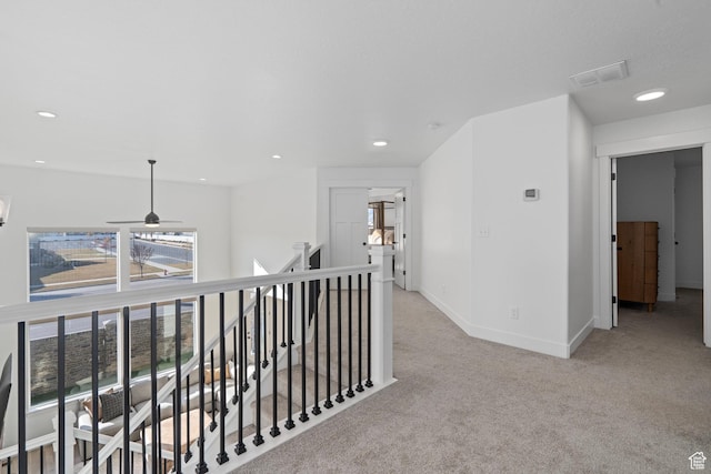 hall with an upstairs landing, visible vents, carpet, baseboards, and recessed lighting