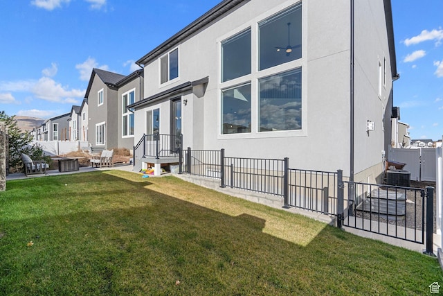 exterior space with stucco siding, fence, a residential view, a yard, and a patio area