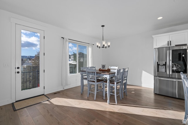 dining area with a notable chandelier, wood-type flooring, baseboards, visible vents, and recessed lighting