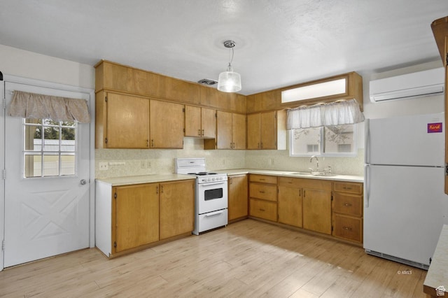 67 W 300 S, Kanab, UT 84741 - kitchen featuring white appliances, a wall mounted AC, light countertops, and a sink