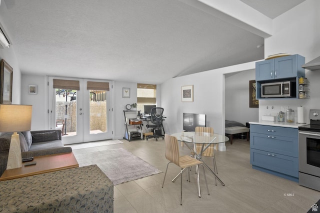 67 W 300 S, Kanab, UT 84741 - kitchen with stainless steel appliances, lofted ceiling, open floor plan, blue cabinets, and french doors