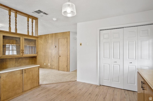 67 W 300 S, Kanab, UT 84741 - interior space featuring light countertops, visible vents, glass insert cabinets, decorative light fixtures, and light wood-type flooring