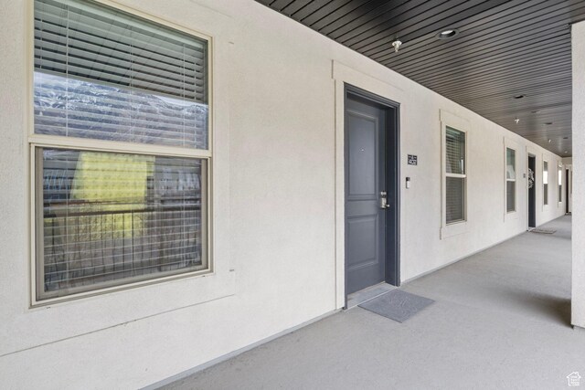 doorway to property featuring stucco siding