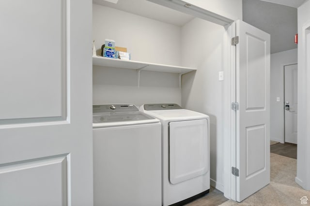 laundry area with washing machine and clothes dryer, baseboards, and laundry area