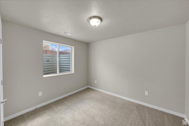 2367 N Monarch Cir E, Cedar City, UT 84721 - empty room featuring carpet, baseboards, and a textured ceiling