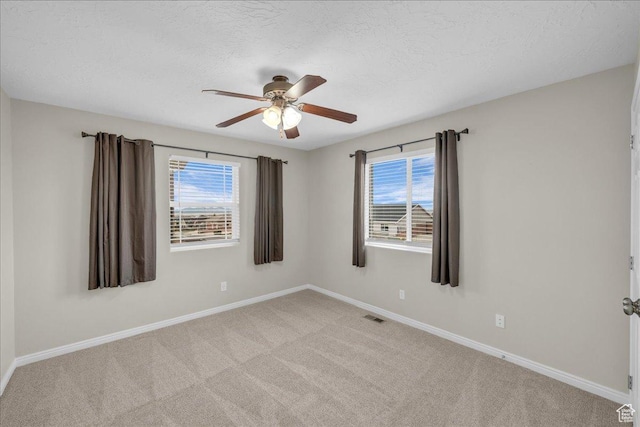 2367 N Monarch Cir E, Cedar City, UT 84721 - unfurnished room with plenty of natural light, ceiling fan, baseboards, light colored carpet, and a textured ceiling
