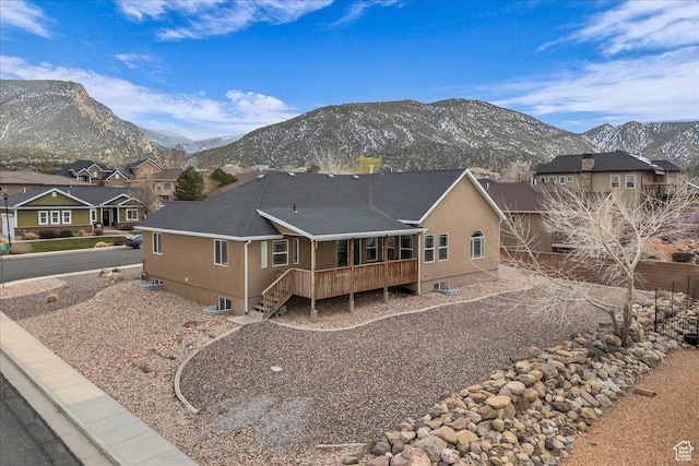2367 N Monarch Cir E, Cedar City, UT 84721 - back of house with a mountain view, a residential view, stucco siding, and stairway