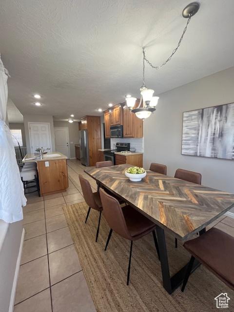 2367 N Monarch Cir E, Cedar City, UT 84721 - dining area featuring light tile patterned flooring, a chandelier, and recessed lighting