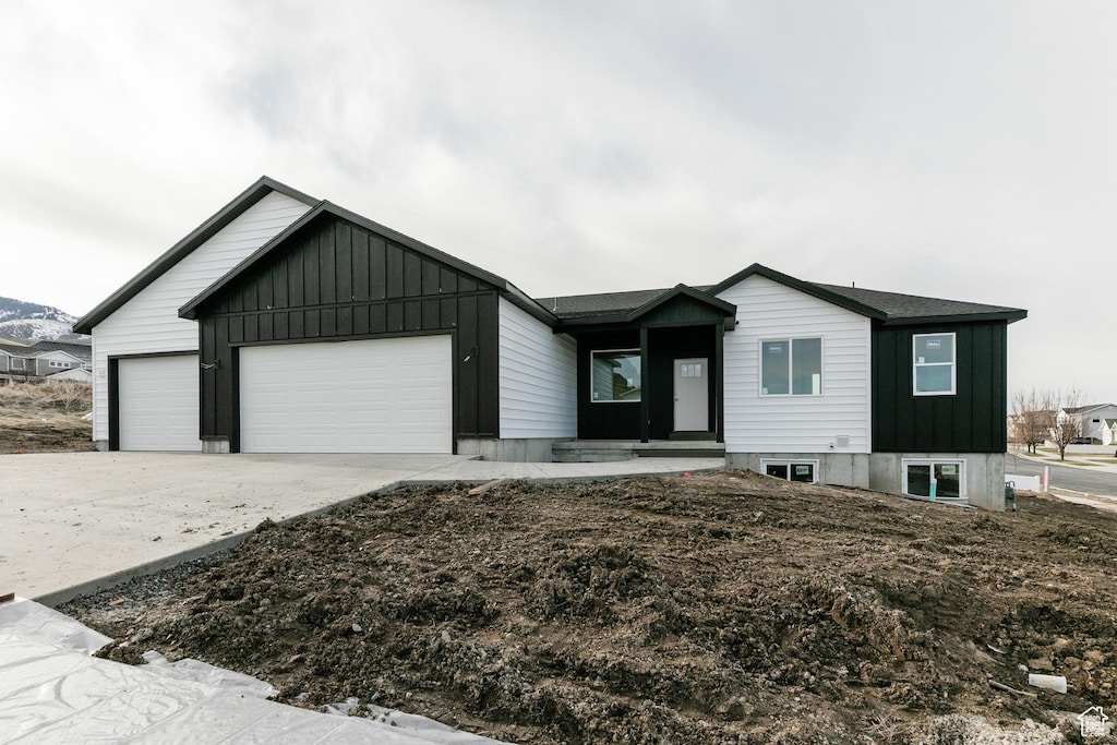 1164 E 30 S, Smithfield, UT 84335 - view of front of property with driveway, a garage, and board and batten siding