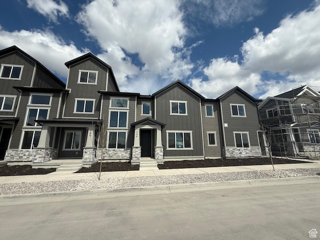view of front of property featuring stone siding and board and batten siding