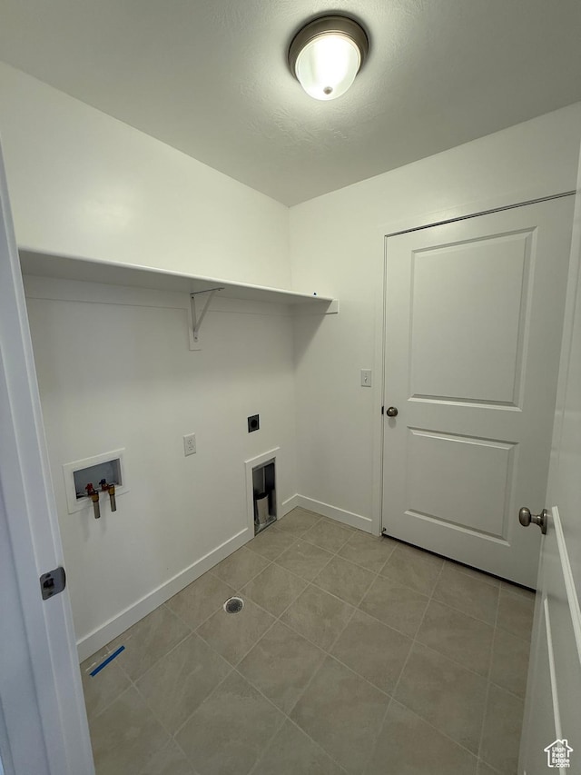 laundry area with hookup for an electric dryer, hookup for a washing machine, baseboards, tile patterned floors, and laundry area