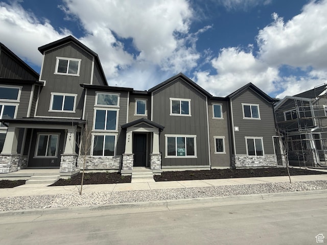view of front of home featuring stone siding and board and batten siding