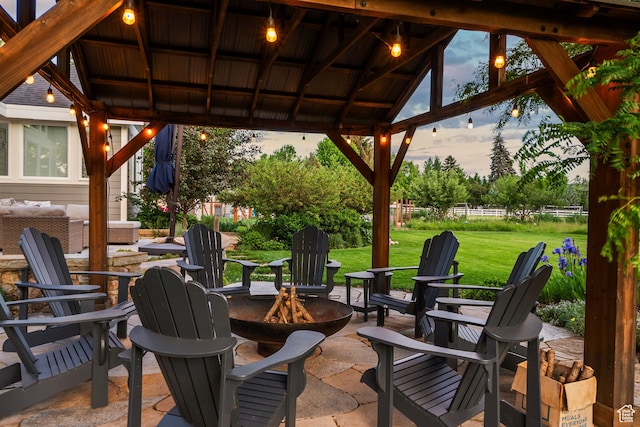 129 S 7200 E, Huntsville, UT 84317 - patio terrace at dusk featuring a fire pit, a patio, a lawn, and a gazebo