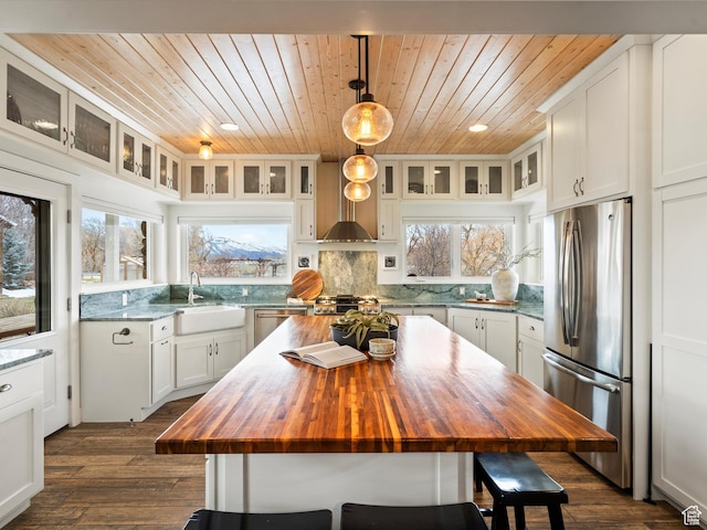 129 S 7200 E, Huntsville, UT 84317 - kitchen with tasteful backsplash, a kitchen breakfast bar, butcher block counters, stainless steel appliances, and a sink