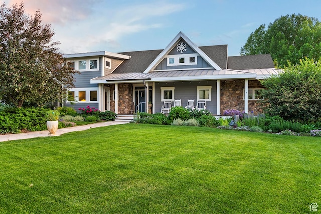 129 S 7200 E, Huntsville, UT 84317 - view of front of property featuring stone siding, a standing seam roof, a front yard, and a metal roof