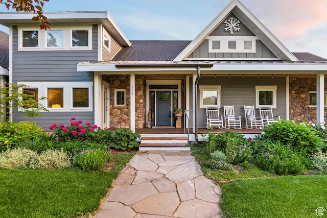 129 S 7200 E, Huntsville, UT 84317 - view of front of property featuring stone siding, covered porch, board and batten siding, and a shingled roof