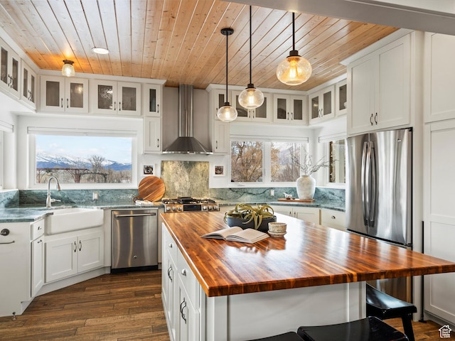 129 S 7200 E, Huntsville, UT 84317 - kitchen with wall chimney exhaust hood, appliances with stainless steel finishes, a sink, butcher block countertops, and backsplash