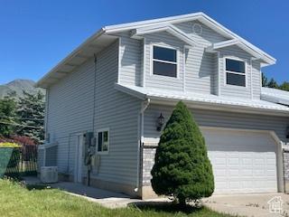 567 S Hazel Dr, Salem, UT 84653 - view of property exterior with a garage and concrete driveway