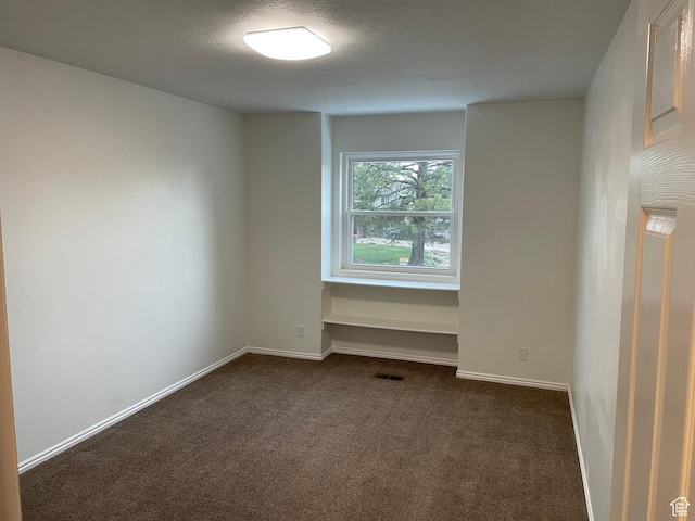 567 S Hazel Dr, Salem, UT 84653 - unfurnished room featuring dark carpet, baseboards, and a textured ceiling