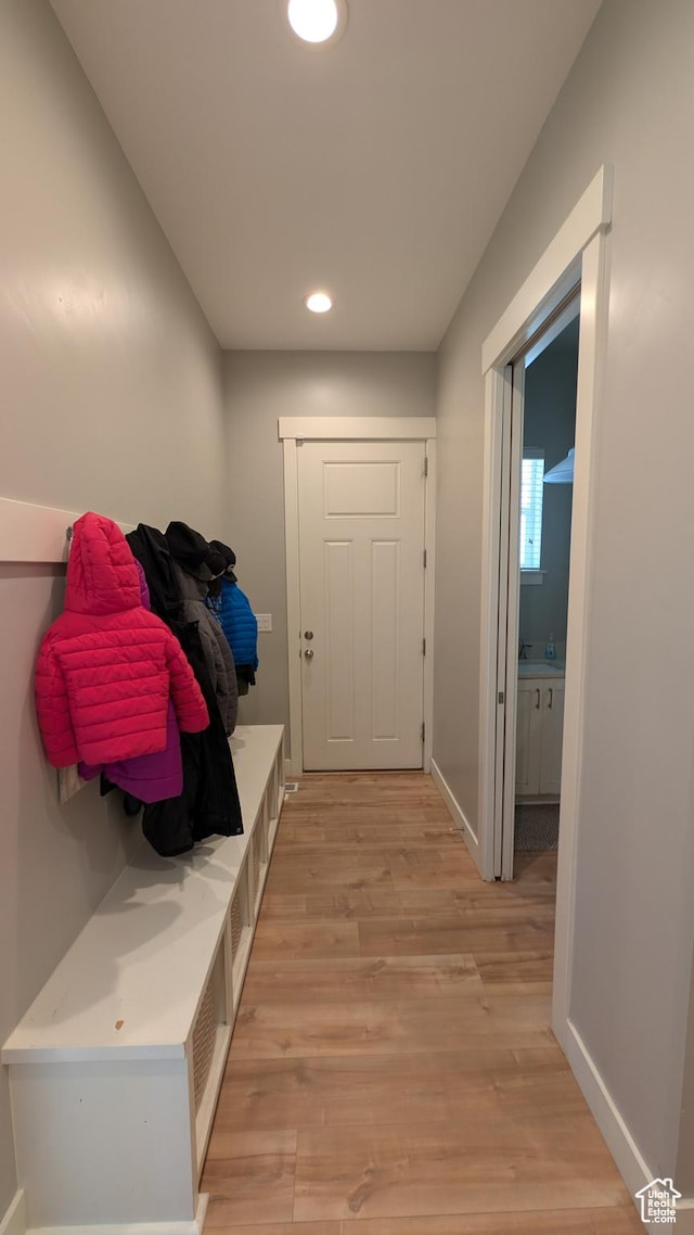 mudroom with baseboards, recessed lighting, and light wood-type flooring