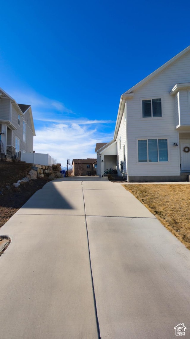 view of side of property with concrete driveway