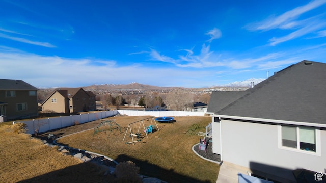 view of yard featuring a fenced backyard and a mountain view