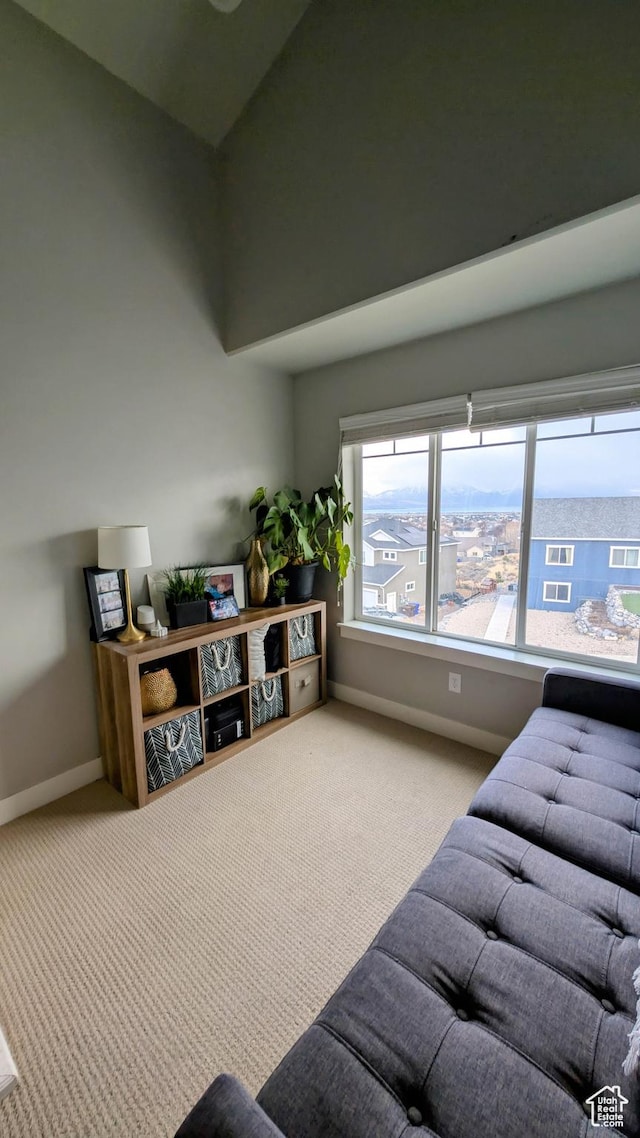 carpeted living room featuring baseboards