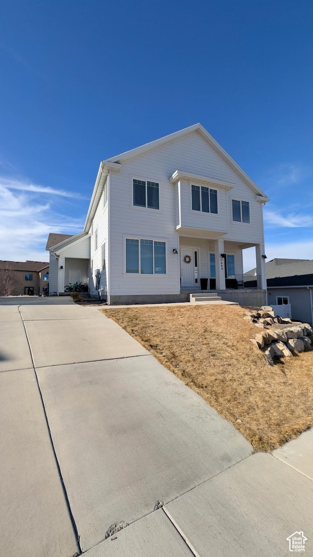view of front of property featuring a porch and a garage