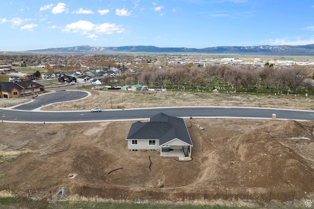 birds eye view of property with a mountain view