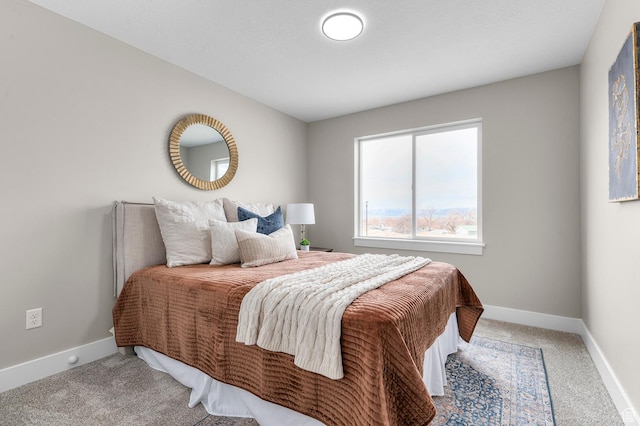 bedroom with baseboards and carpet