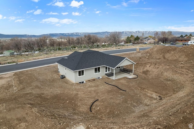 birds eye view of property with a mountain view