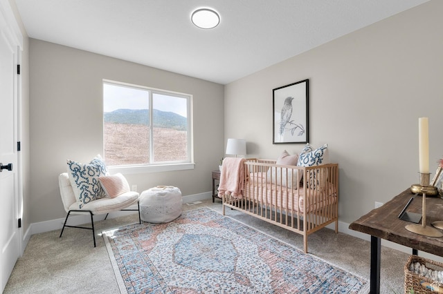 bedroom featuring carpet, baseboards, and a mountain view