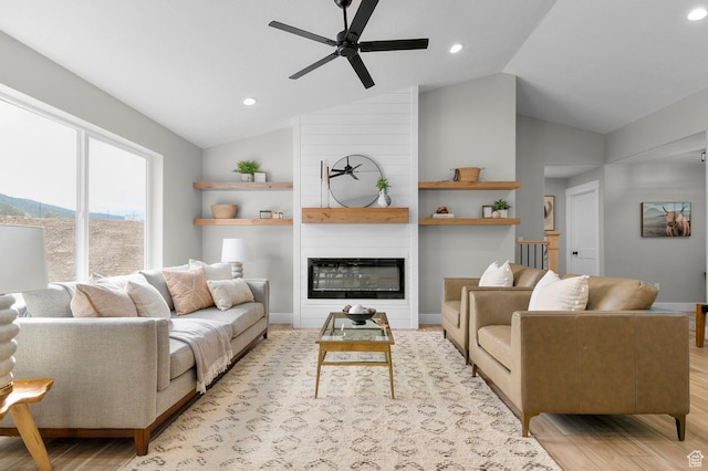 living room featuring recessed lighting, a fireplace, lofted ceiling, light wood finished floors, and ceiling fan