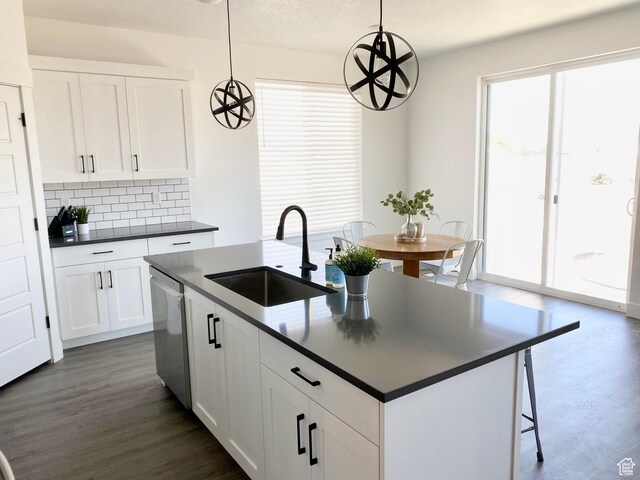 471 E 600 S, Hyrum, UT 84319 - kitchen with a sink, dark countertops, backsplash, dark wood finished floors, and dishwasher