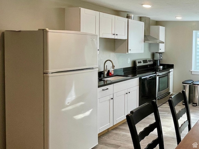 471 E 600 S, Hyrum, UT 84319 - kitchen featuring freestanding refrigerator, wall chimney range hood, stainless steel range with electric stovetop, a sink, and dark countertops