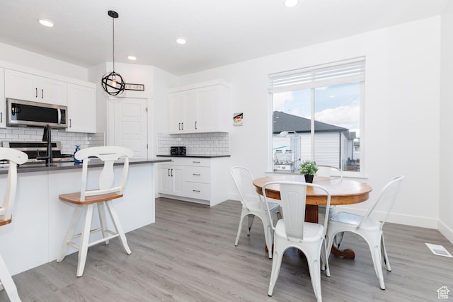 471 E 600 S, Hyrum, UT 84319 - kitchen with stainless steel appliances, dark countertops, light wood-type flooring, and recessed lighting