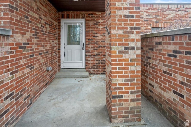 property entrance with brick siding