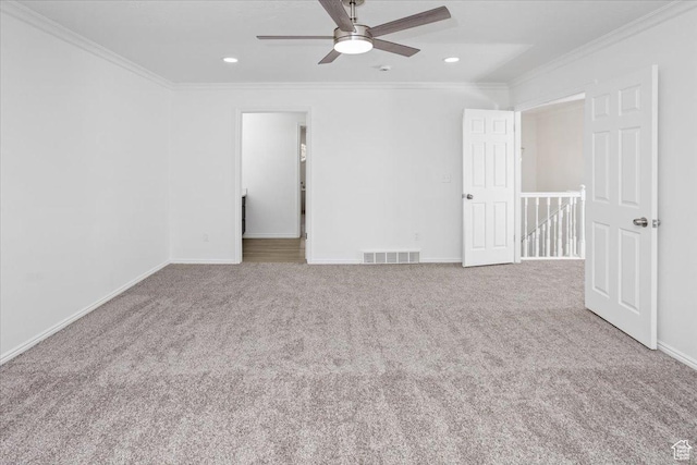 unfurnished bedroom with baseboards, carpet floors, visible vents, and crown molding