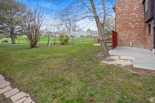 view of yard featuring fence and a patio area