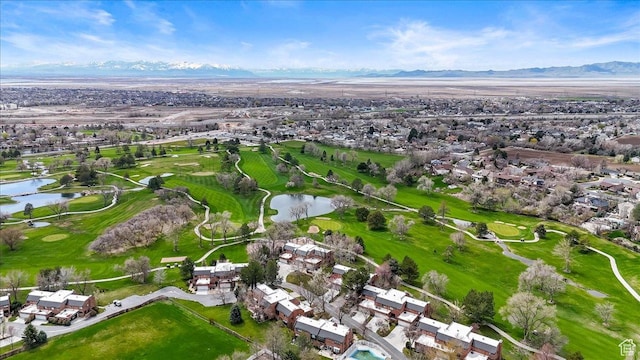 birds eye view of property featuring a water and mountain view, view of golf course, and a residential view